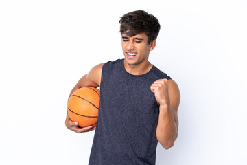Young caucasian man isolated on white background playing basketball