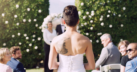 Bride, wedding and walking by aisle with marriage, commitment and love for groom or partner. Woman, ceremony and processional entrance for matrimony, loyalty and union outdoor with audience or crowd