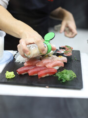 chef making tuna and salmon sushi