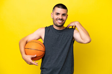 Young caucasian basketball player man isolated on yellow background laughing