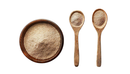 Bowl and spoon with active dry yeast isolated on white
