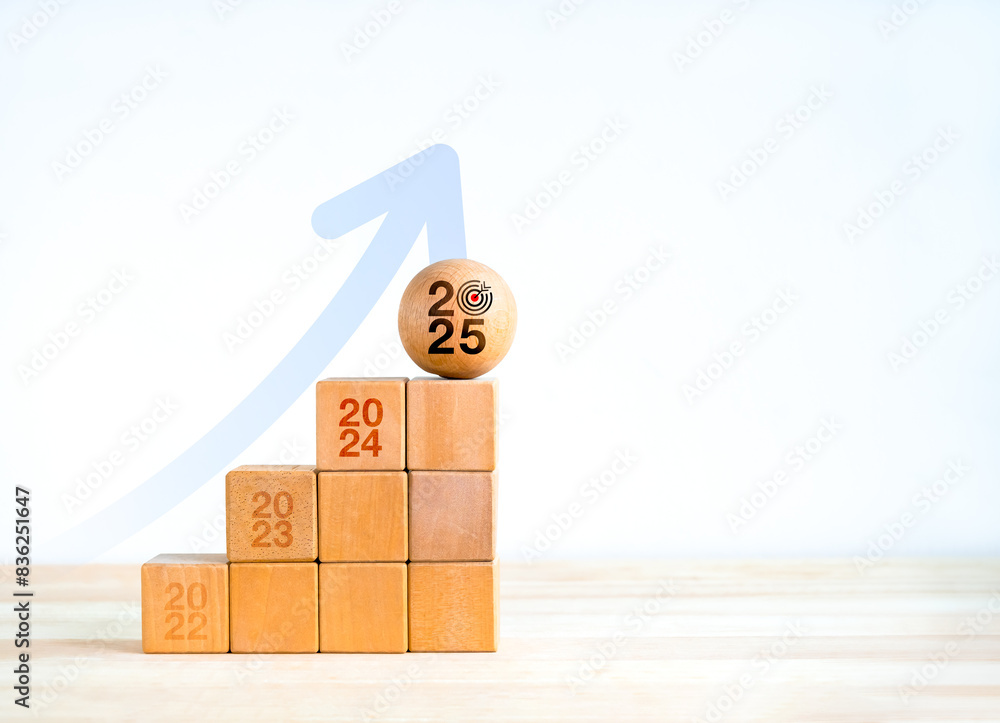 Poster 2025 year number with target icon on wood sphere on eco cube blocks as growth graph steps with big r