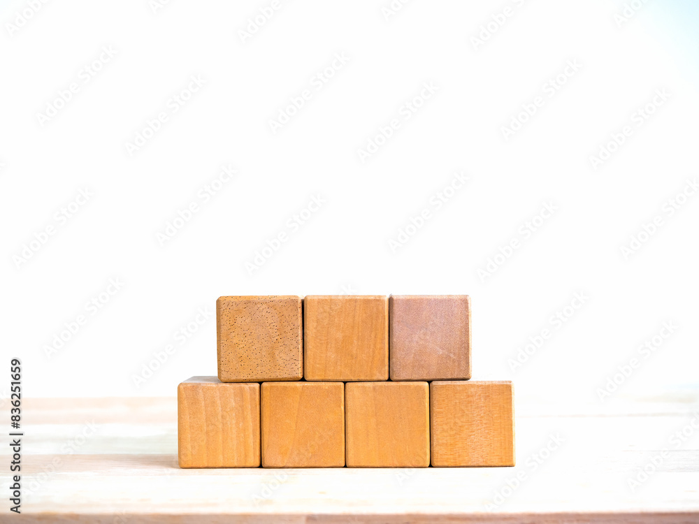 Poster 5 wood blocks stack isolated on wooden table, white banner background with copy space. empty blank t