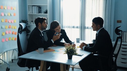 Smart businessman join meeting while marketing team talking plan at table with colorful sticky...
