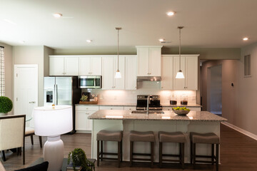 Interior Design of a beautiful modern kitchen with center island. Real estate concept.