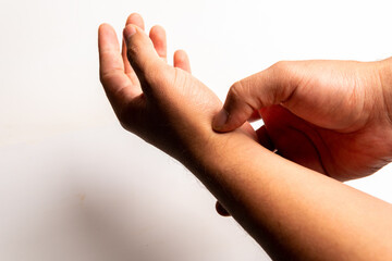 Close up of an arm with pain in the wrist, on a white background
