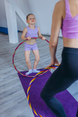 Gymnast child performs an exercise with hoop.Children's professional sports. 