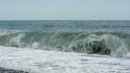 waves crashing on black sand beach