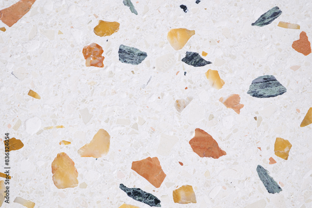 Poster A background with a lot of different colored rocks scattered all over it. The rocks are of various sizes and colors, creating a visually interesting and unique pattern
