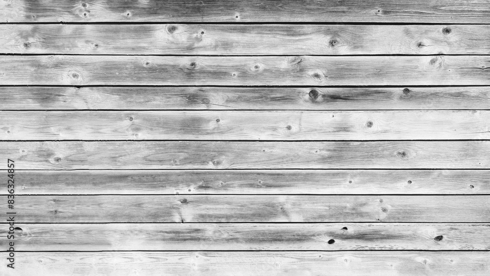Poster A wooden board with a grainy texture and a few holes. The board is white and has a rustic feel to it