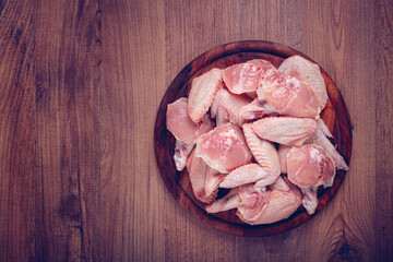 Raw chicken wings, on a wooden board, top view, no people,