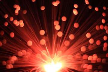 Mystical red and black background with a light source from below, diverging rays and lights at the ends