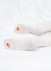 Anti-embolic Compression Hosiery. Medical stockings, tights, socks, calves and sleeves for varicose veins and venouse therapy. Clinical knits. Sock for sports on white background