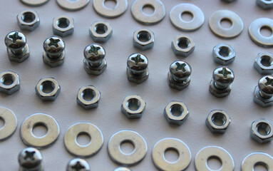  Lines Of Metallic Hardware Items On A White Surface Of Workbench. Macro Shot Stock Photo For...