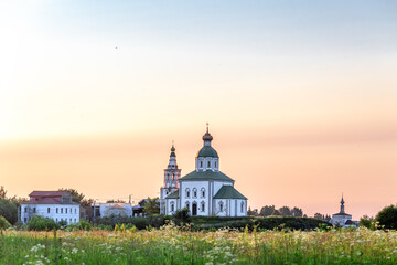 SUZDAL, RUSSIA - Beautiful landscape of Suzdal overlooking the Kamenka River and the ancient Russian Church of Elijah the Prophet (Ilyinsky Church)At sunset