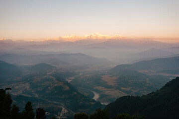 Stunning sunrise view over the misty valley of Bandipur, Nepal, with the majestic Himalayas...