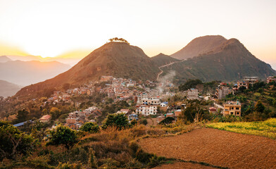 Sunset casting a warm glow over the charming town of Bandipur, Nepal, surrounded by verdant hills...