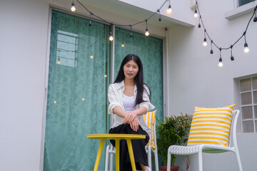 Portrait of Asian woman sitting outdoors and relaxing