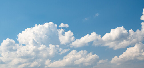 Cumulus humilis (cumuliform) clouds on the bright blue sky on a sunny day