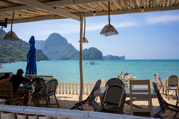 Dining area of a beachside restaurant in El Nido, Philippines, with stunning ocean and island views...