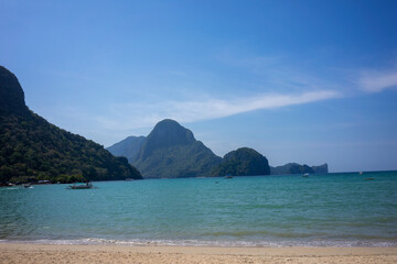 Scenic beach of El Nido, Philippines, with turquoise waters and lush vegetation creating a perfect tropical paradise