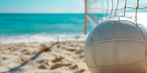 Beach volleyball court with ball on sandy beach near the sea, net and blue sky. Perfect for summer vacation promotions, travel blogs, and sports event advertising, featuring ample copy space for text