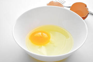 Egg yolk in a white bowl. Cooking preparation concept. 