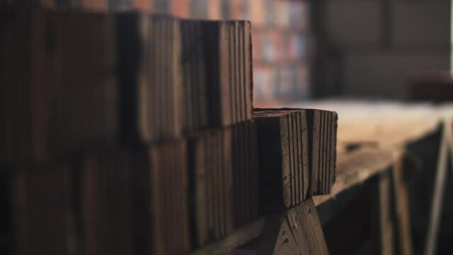 Builder stacking bricks with hands