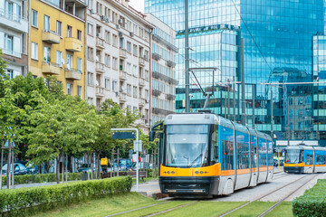 Modern Tram Traveling Through City Streets