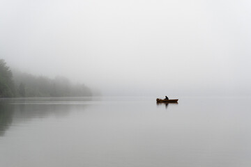 Fisherman and Rowing boat on a Misty Lake