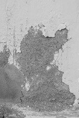 A wall with a lot of cracks and holes