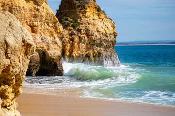 View of idyllic nature landscape with rocky cliff shore and waves crashing on. Camillo beach in...