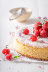 Homemade and sweet cheesecake made with sugar and raspberries.