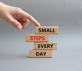 Small Steps Every Day symbol. Wooden blocks with words Small Steps Every Day. Beautiful grey...