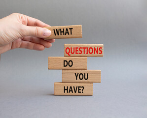Questions symbol. Wooden blocks with words What Questions do you have. Beautiful grey background....