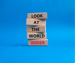 Look at the world wider symbol. Wooden blocks with words Look at the world wider. Beautiful blue...