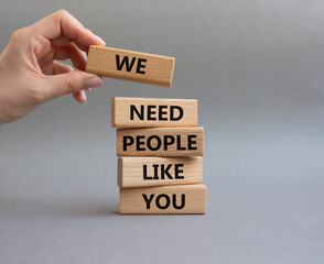 Hiring symbol. Wooden blocks with words We need People like You. Businessman hand. Beautiful grey...