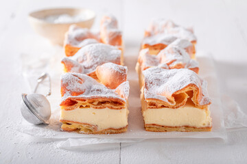 Homemade and sweet Karpatka cake with cream and pastry dough.