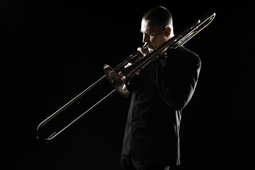 Trombone player. Trombonist playing brass instrument. Classical musician