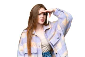 Young pretty woman over isolated chroma key background looking far away with hand to look something