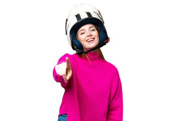 Young pretty woman with a motorcycle helmet over isolated chroma key background pointing front with happy expression