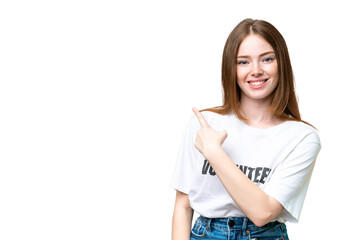 Young volunteer woman over isolated chroma key background pointing to the side to present a product
