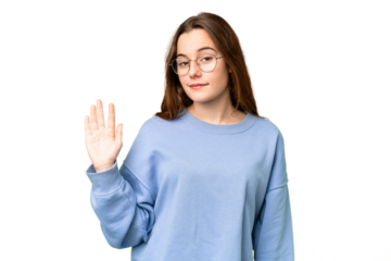 Teenager girl over isolated chroma key background saluting with hand with happy expression