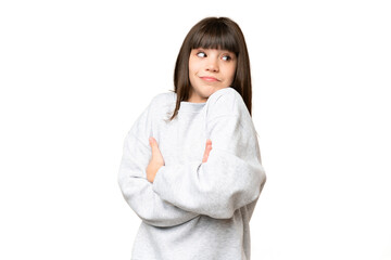 Little girl over isolated green chroma key background making doubts gesture while lifting the shoulders