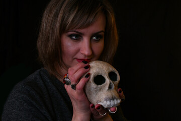 portrait of a witch woman with a skull in her hand