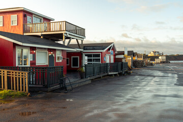 A strip mall with simple 1 and 2 story buildings housing restaurants, vendors and services for...