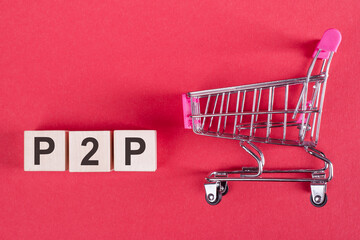 A tiny cart with P2P blocks highlights peer-to-peer commerce concept.