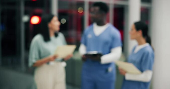 Medical staff, discussion and teamwork with clipboard in hospital for healthcare as professional in ER. Group, people and blurred in collaboration, meeting or brainstorming in clinic with paperwork