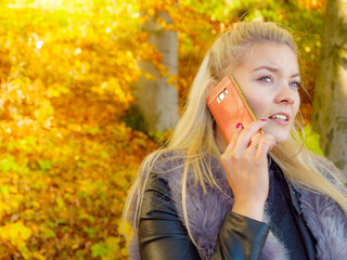 Fashion female talking on mobile phone outdoor