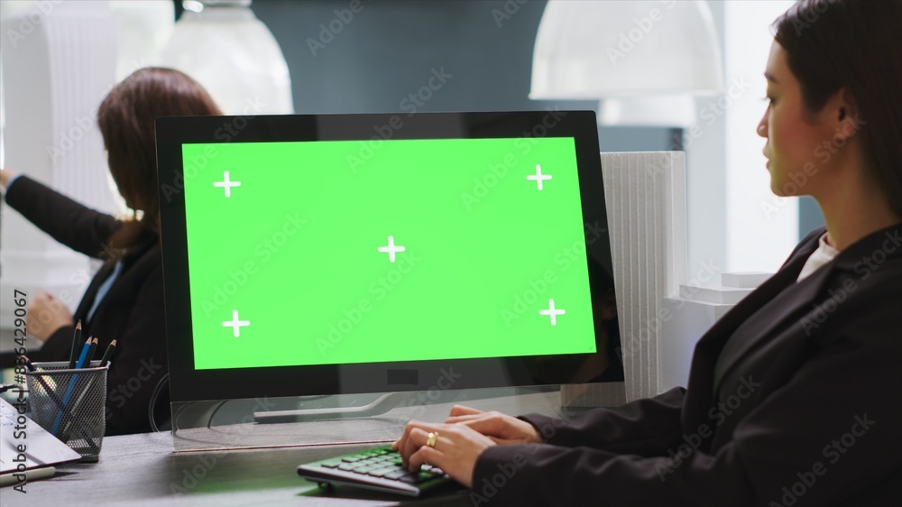 Poster cad designer using pc with greenscreen at workstation area, examining monitor with blank copyspace d